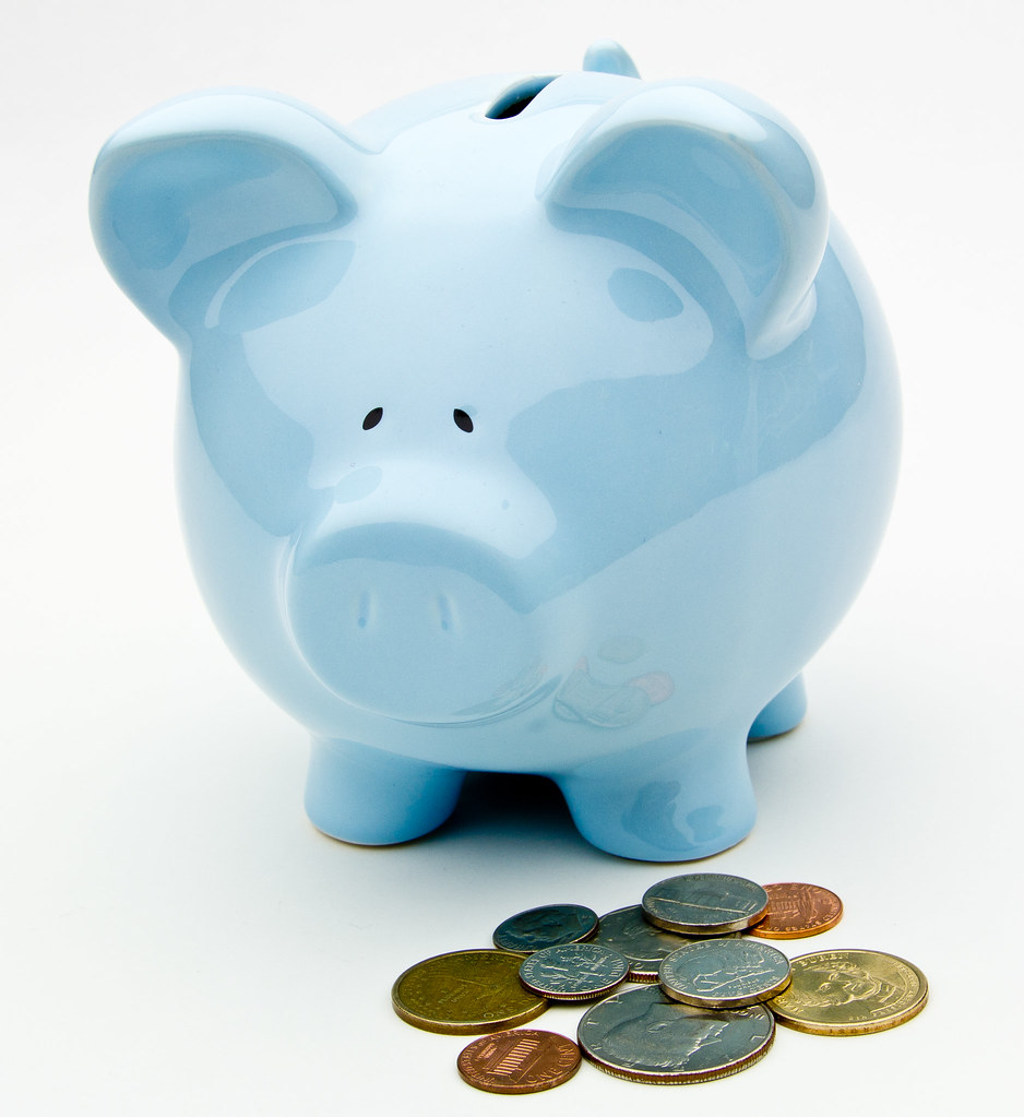 Piggy bank and coins representing retirement plan savings