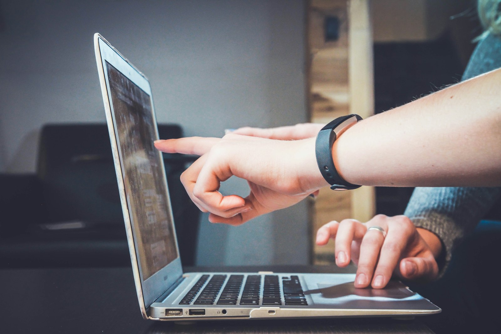 Marketing professional reviewing an email campaign dashboard on a laptop.
