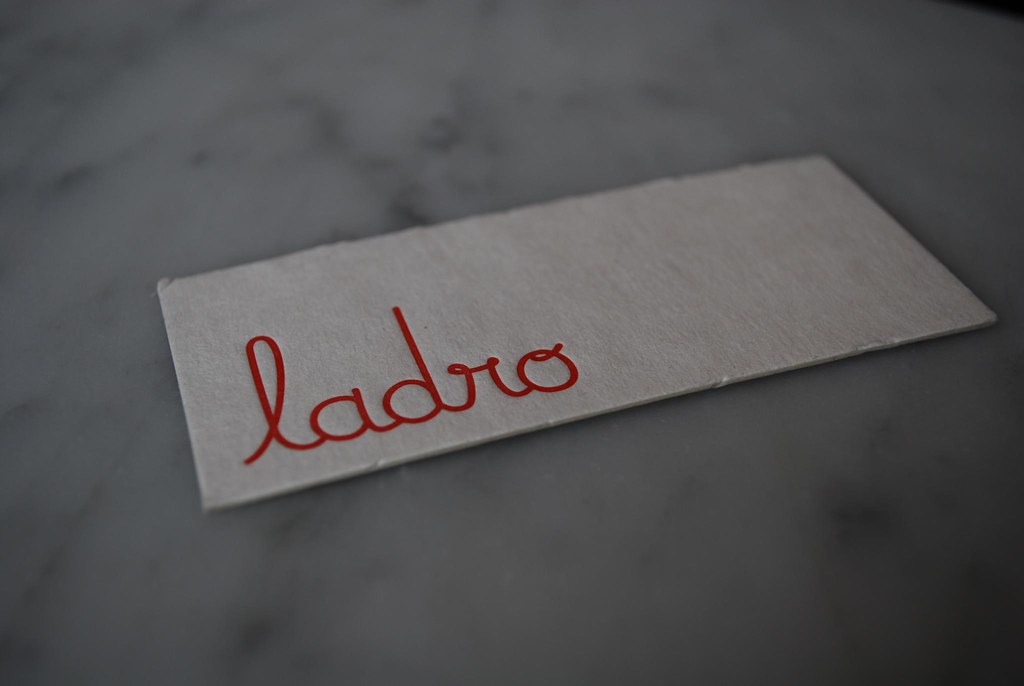 Close-up of a printed business card resting on a tabletop.